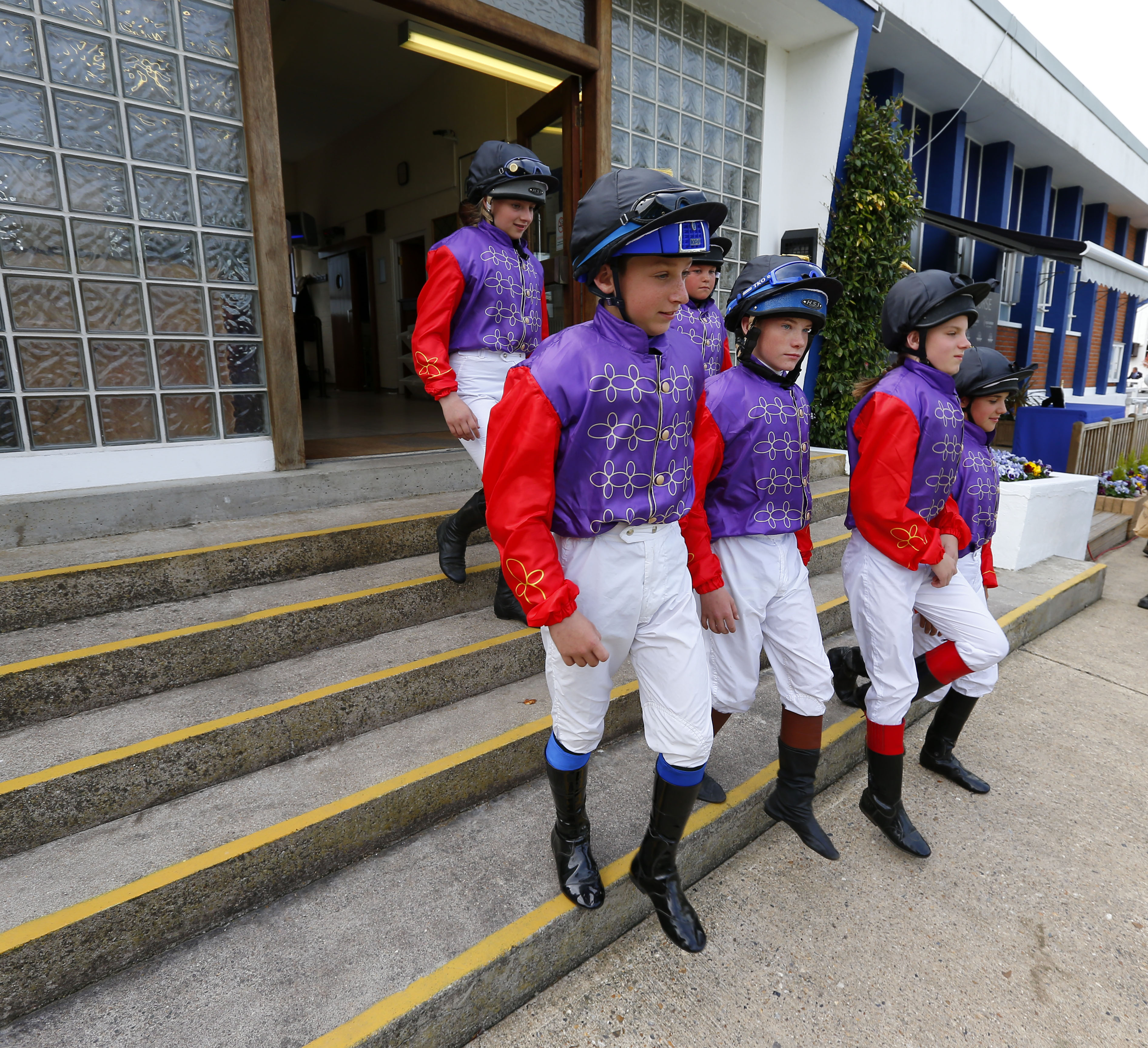 Jockeys walk out of the parade ring
