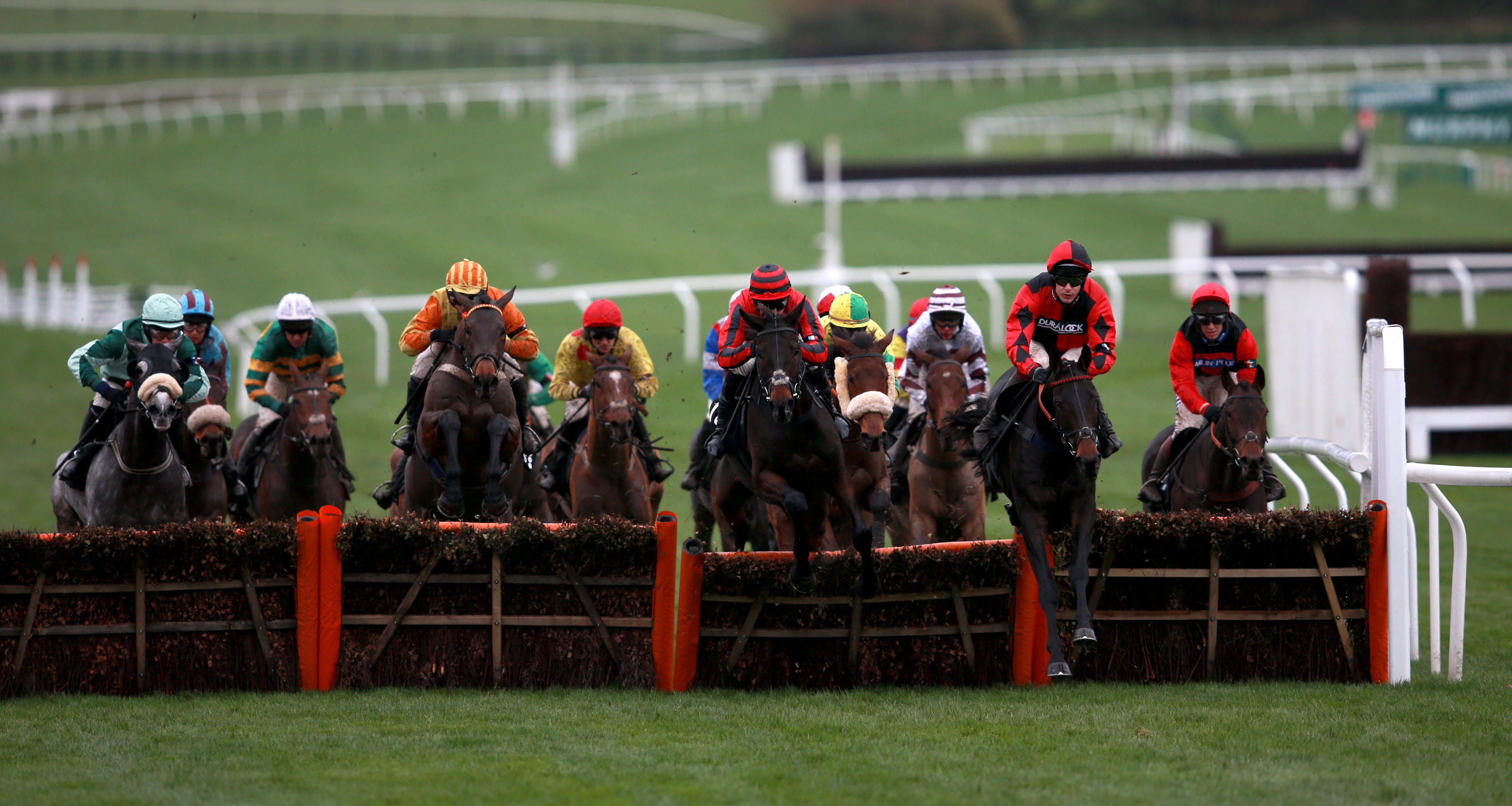 Sir Mangan (right) ridden by Harry Skelton jumps the fence during the Regulatory Finance Solutions Handicap Hurdle © David Davies/PA Wire/Cheltenham Racecourse